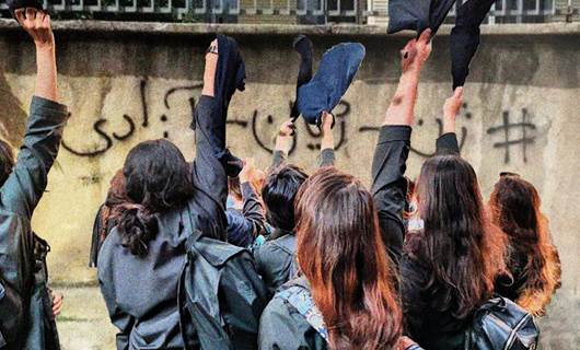 Women in Iran wave their hijabs in the air in protest of the country’s mandatory hijab law. A street in Iran with the graffiti Jin Jiyan Azadi, or Women Life Freedom. Photos: Social media