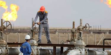Workers at an oil refinery in Nasiriya, southern Iraq. File photo: AFP
